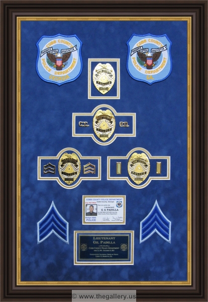 Cobb County Police Department retirement shadow box with police badges, patches, ID cards and lapel pins.






The Gallery at Brookwood
www.thegallery.us
770-941-3394
Your Custom Framing Expert
Picture Framing Examples
Custom Framing Examples
Shadowbox Examples
Police_Department_retirement_shadow_box_with_badge