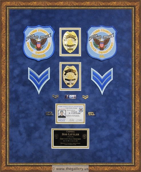 Cobb County Police Department retirement shadow box with police badges, patches, ID cards and lapel pins.






The Gallery at Brookwood
www.thegallery.us
770-941-3394
Your Custom Framing Expert
Picture Framing Examples
Custom Framing Examples
Shadowbox Examples
ccpd38