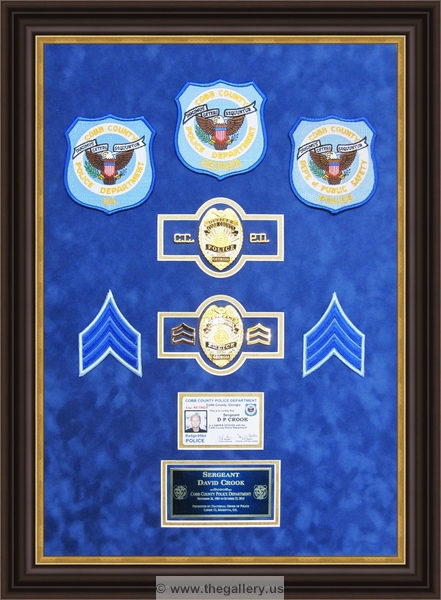 Cobb County Police Department retirement shadow box with police badges, patches, ID cards and lapel pins.






The Gallery at Brookwood
www.thegallery.us
770-941-3394
Your Custom Framing Expert
Picture Framing Examples
Custom Framing Examples
Shadowbox Examples
cobb_county_police_retirement_shadow_box