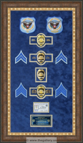 Cobb County Police Department retirement shadow box with police badges, patches, ID cards and lapel pins.






The Gallery at Brookwood
www.thegallery.us
770-941-3394
Your Custom Framing Expert
Picture Framing Examples
Custom Framing Examples
Shadowbox Examples
police-shadow-box