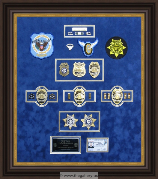Cobb County Police Department retirement shadow box with police badges, patches, ID cards and lapel pins.


military shadow box with flag, 



The Gallery at Brookwood
www.thegallery.us
770-941-3394
Your Custom Framing Expert
Picture Framing Examples
Custom Framing Examples
Shadowbox Examples
police-shadowbox-badges-patches