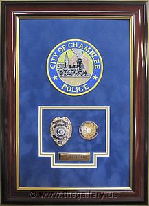  Police Department retirement shadow box with police badges, patches, ID cards and lapel pins. 

The Gallery at Brookwood
www.thegallery.us
770-941-3394
Your Custom Framing Expert
Picture Framing Examples
Custom Framing Examples
Shadowbox Examples