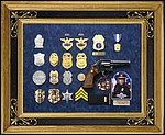 Police retirement shadow box with gun, badges, patchs, photo, lapel pins and awards.
kennesaw_georgia_frame_shop.jpg