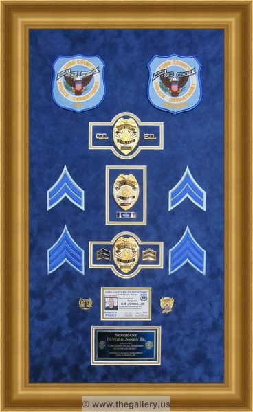 Cobb County Police Department retirement shadow box with police badges, patches, ID cards and lapel pins.






The Gallery at Brookwood
www.thegallery.us
770-941-3394
Your Custom Framing Expert
Picture Framing Examples
Custom Framing Examples
Shadowbox Examples
Police_Department_retirement_shadow_box_with_badges_5