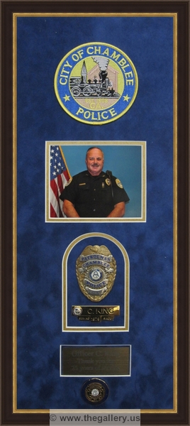 Cobb County Police Department retirement shadow box with police badges, patches, ID cards and lapel pins.






The Gallery at Brookwood
www.thegallery.us
770-941-3394
Your Custom Framing Expert
Picture Framing Examples
Custom Framing Examples
Shadowbox Examples
police-department-retirement-gift