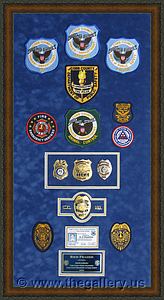 Police Department retirement shadow box with police badges, patches, ID cards and lapel pins.

The Gallery at Brookwood
www.thegallery.us
770-941-3394
Your Custom Framing Expert
Picture Framing Examples
Custom Framing Examples
Shadowbox Examples