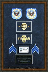 Police Department retirement shadow box with police badges, patches, ID cards and lapel pins.

The Gallery at Brookwood
www.thegallery.us
770-941-3394
Your Custom Framing Expert
Picture Framing Examples
Custom Framing Examples
Shadowbox Examples