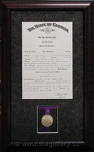Framed certificate with medal.

The Gallery at Brookwood
www.thegallery.us
770-941-3394
Your Custom Framing Expert
Picture Framing Examples
Custom Framing Examples
Shadowbox Examples