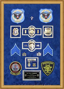Cobb County Police Department retirement shadow box with police badges, patches, ID cards and lapel pins.

The Gallery at Brookwood
www.thegallery.us
770-941-3394
Your Custom Framing Expert
Picture Framing Examples
Custom Framing Examples
Shadowbox Examples