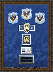 Police Department retirement shadow box with police badges, patches, ID cards and lapel pins.

The Gallery at Brookwood
www.thegallery.us
770-941-3394
Your Custom Framing Expert
Picture Framing Examples
Custom Framing Examples
Shadowbox Examples