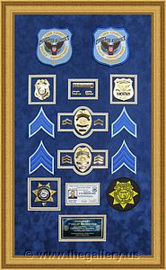 Cobb County Police Department retirement shadow box with police badges, patches, ID cards and lapel pins.

The Gallery at Brookwood
www.thegallery.us
770-941-3394
Your Custom Framing Expert
Picture Framing Examples
Custom Framing Examples
Shadowbox Examples