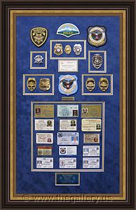 Cobb County Police Department retirement shadow box with police badges, patches, ID cards and lapel pins.

The Gallery at Brookwood
www.thegallery.us
770-941-3394
Your Custom Framing Expert
Picture Framing Examples
Custom Framing Examples
Shadowbox Examples