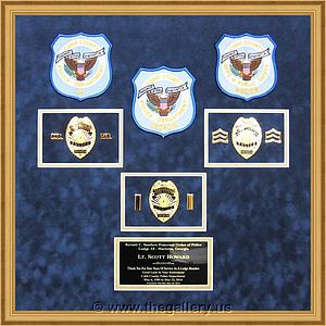 Cobb County Police Department retirement shadow box with police badges, patches, ID cards and lapel pins.

The Gallery at Brookwood
www.thegallery.us
770-941-3394
Your Custom Framing Expert
Picture Framing Examples
Custom Framing Examples
Shadowbox Examples