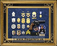 Police retirement shadow box with gun, badges, patchs, photo, lapel pins and awards.
kennesaw_georgia_frame_shop.jpg